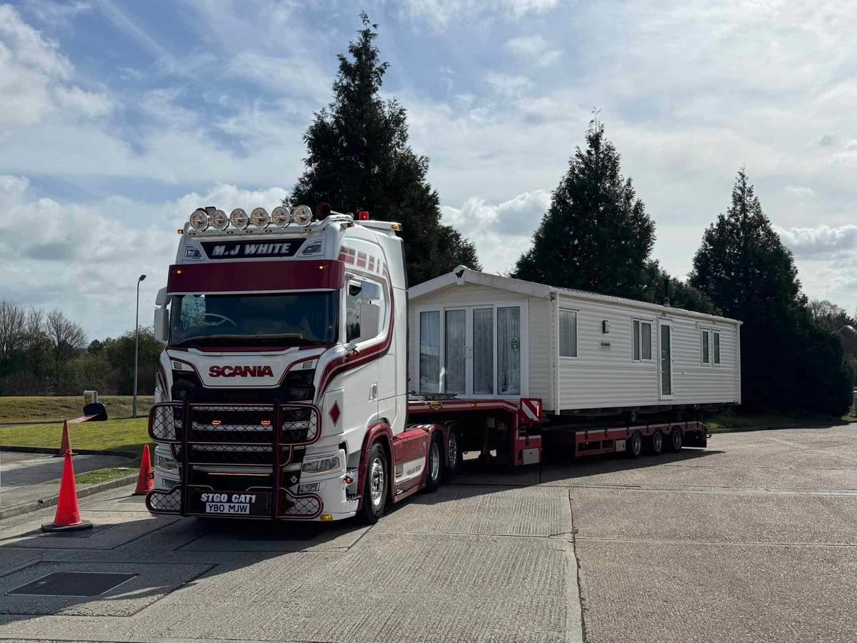 A static caravan loaded on a low-loader, collected from a customer's pitch